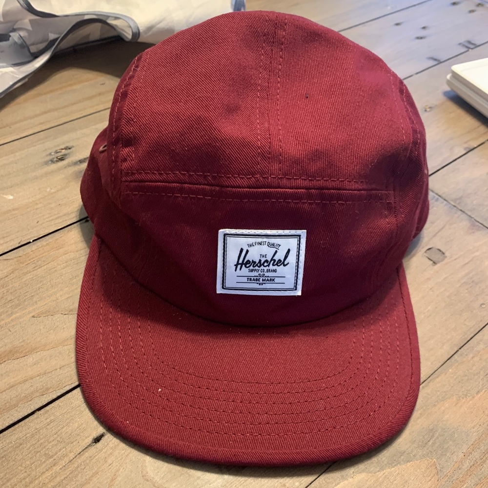 Maroon coloured 5 panel Herschel hat.